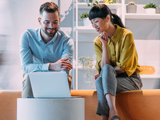Co-workers working on a computer together