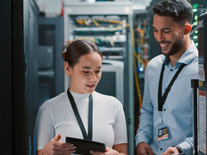 Colleagues working together in a server room